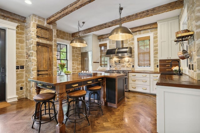 5715 Greenbrier Rd, Franklin, TN 37064 - kitchen with high quality appliances, beam ceiling, a sink, premium range hood, and wood counters