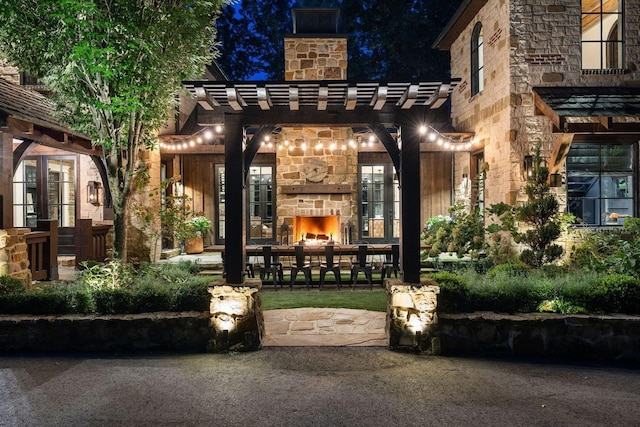 5715 Greenbrier Rd, Franklin, TN 37064 - entrance to property featuring an outdoor stone fireplace, a chimney, a pergola, and stone siding