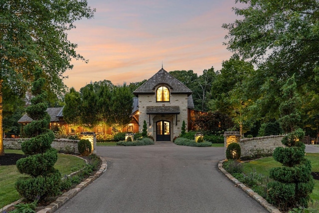 5715 Greenbrier Rd, Franklin, TN 37064 - french country home featuring french doors, curved driveway, and stone siding