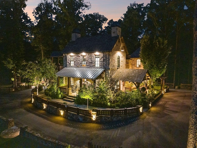 5715 Greenbrier Rd, Franklin, TN 37064 - view of front of home featuring a standing seam roof, covered porch, a chimney, and metal roof