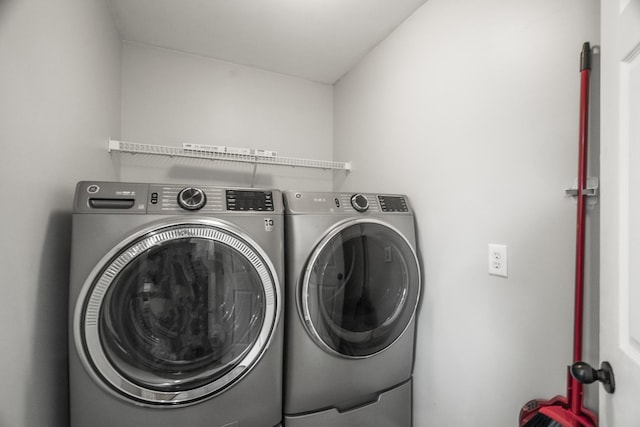 clothes washing area with laundry area and washing machine and clothes dryer