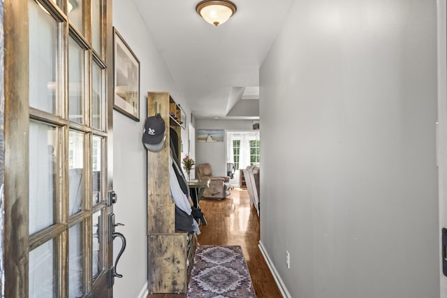 interior space featuring french doors, baseboards, and dark wood-type flooring