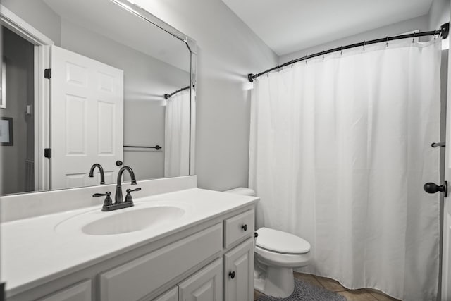 bathroom featuring toilet and vanity