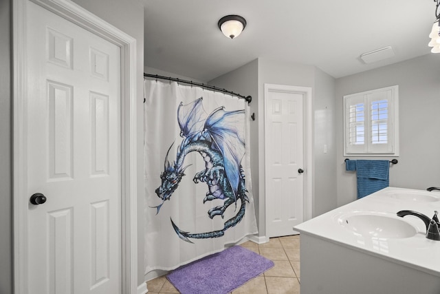 bathroom with a sink, tile patterned flooring, and double vanity