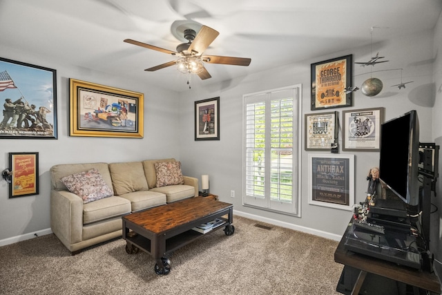living room featuring baseboards, a ceiling fan, and carpet flooring