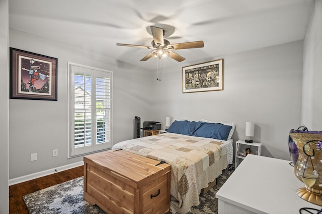 bedroom featuring baseboards, dark wood finished floors, and ceiling fan