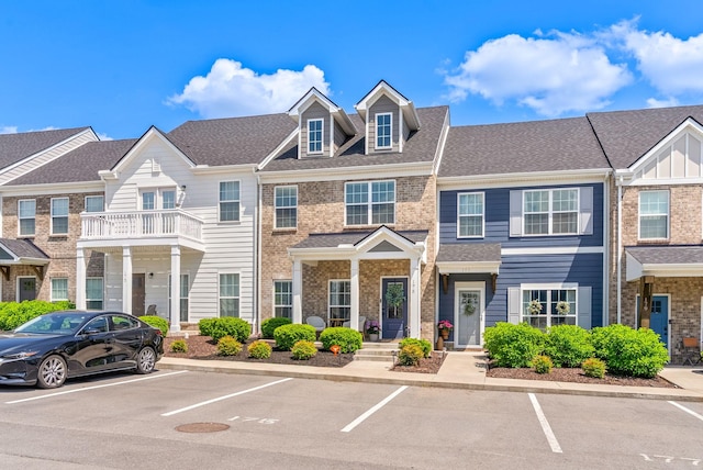 175 Harvard Dr, Gallatin, TN 37066 - townhome / multi-family property featuring a shingled roof, uncovered parking, and brick siding