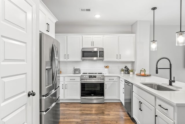 175 Harvard Dr, Gallatin, TN 37066 - kitchen featuring a sink, stainless steel appliances, white cabinetry, a peninsula, and dark wood-type flooring