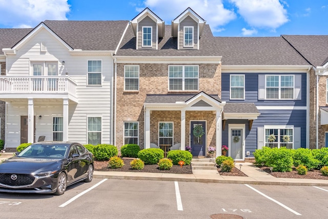 175 Harvard Dr, Gallatin, TN 37066 - view of property featuring brick siding, uncovered parking, and a shingled roof