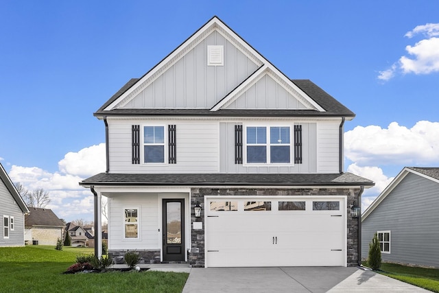 view of front of property featuring a garage, board and batten siding, driveway, and stone siding