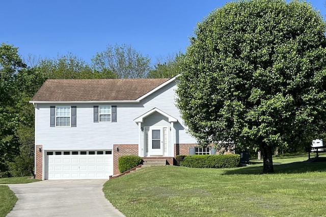 bi-level home featuring brick siding, an attached garage, driveway, and a front lawn