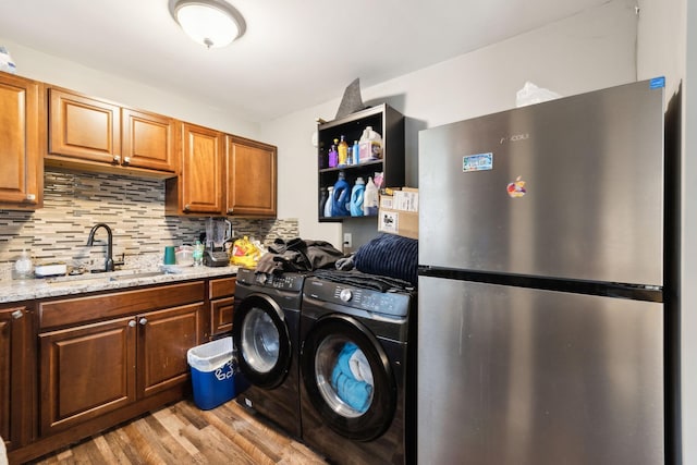 235 Brevard Ct, Nashville, TN 37211 - washroom featuring laundry area, a sink, washer and clothes dryer, and light wood-type flooring