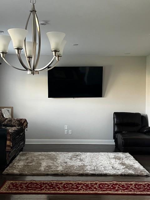 interior details featuring baseboards and a chandelier