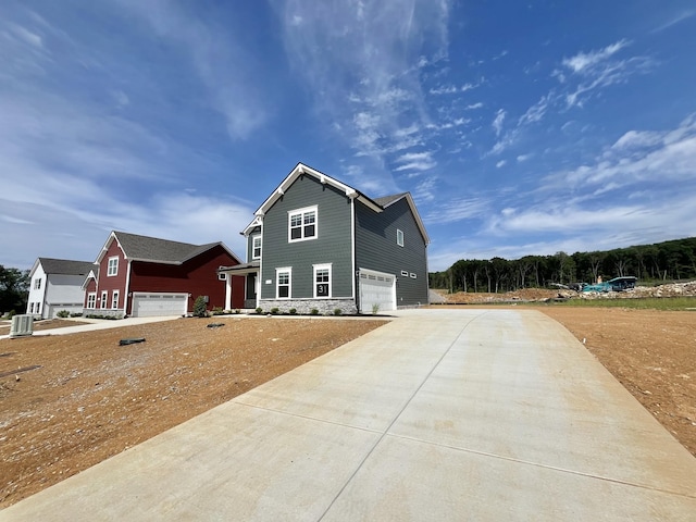 2626 Unitas Dr, Murfreesboro, TN 37129 - view of side of home with an attached garage, driveway, and stone siding