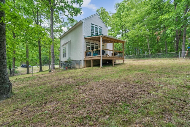 1005 Lauren Cir, Burns, TN 37029 - back of house with a fenced backyard, a wooden deck, and a yard