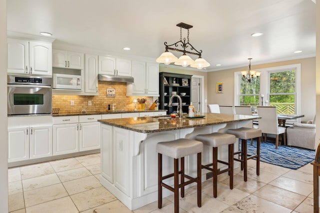 921 Cooks Rd, Mount Juliet, TN 37122 - kitchen featuring stainless steel oven, white microwave, dark stone counters, white cabinetry, and a sink