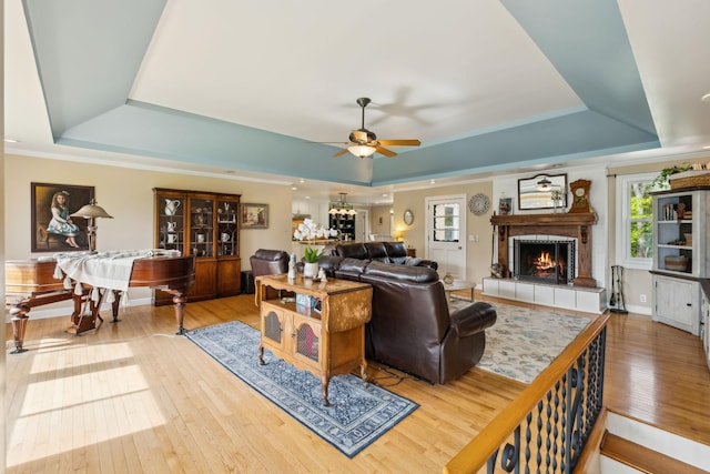 921 Cooks Rd, Mount Juliet, TN 37122 - living area with wood-type flooring, ceiling fan, a tray ceiling, and a fireplace