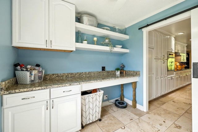 921 Cooks Rd, Mount Juliet, TN 37122 - kitchen featuring stone countertops, white cabinetry, built in desk, and oven