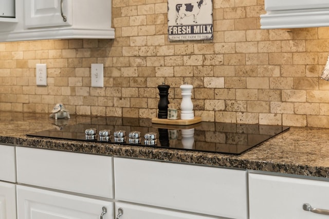 921 Cooks Rd, Mount Juliet, TN 37122 - kitchen featuring decorative backsplash, black electric cooktop, dark stone countertops, and white cabinets