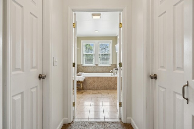 921 Cooks Rd, Mount Juliet, TN 37122 - bathroom with crown molding, baseboards, tile patterned flooring, and a garden tub