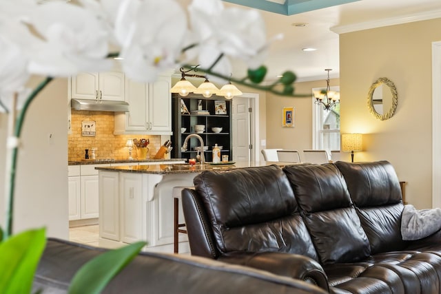 921 Cooks Rd, Mount Juliet, TN 37122 - living area with crown molding, recessed lighting, an inviting chandelier, and light tile patterned floors