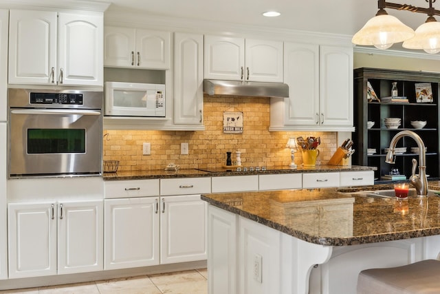 921 Cooks Rd, Mount Juliet, TN 37122 - kitchen with a sink, white microwave, black electric stovetop, under cabinet range hood, and oven