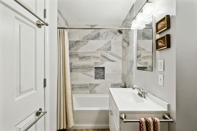 bathroom featuring vanity and shower / bath combination with curtain