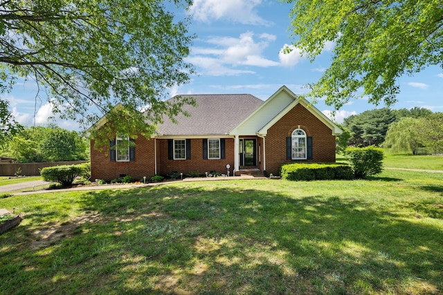 ranch-style home featuring brick siding and a front yard