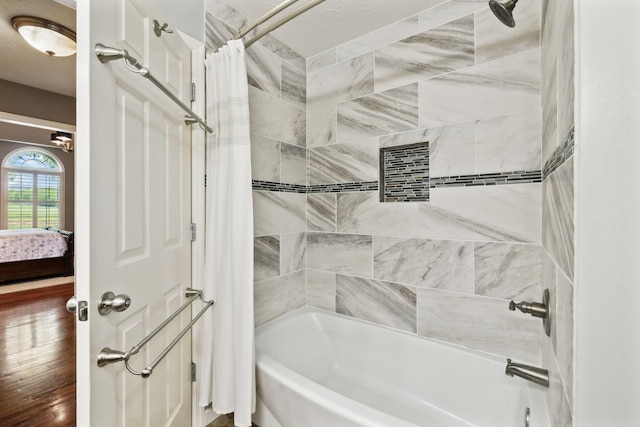 full bathroom with wood finished floors and shower / tub combo with curtain