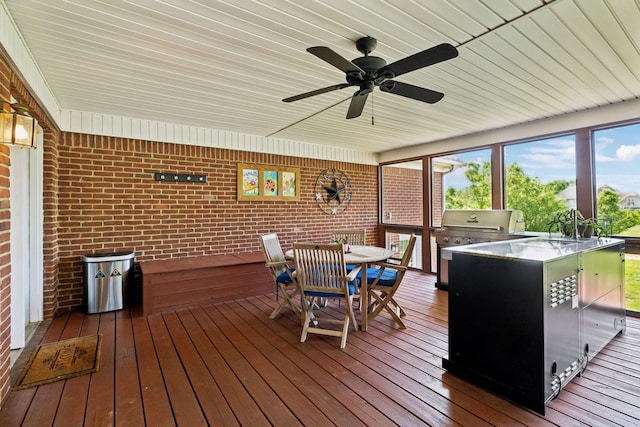wooden deck featuring area for grilling, ceiling fan, and outdoor dining space