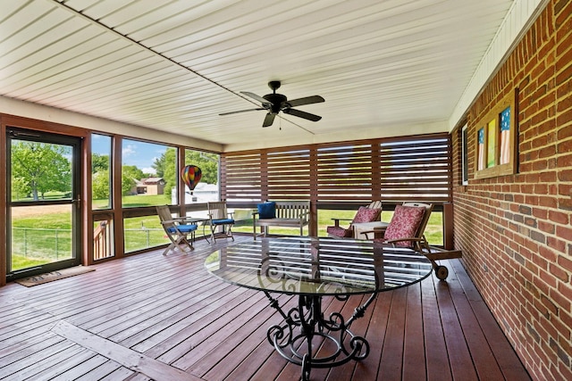 sunroom featuring a ceiling fan