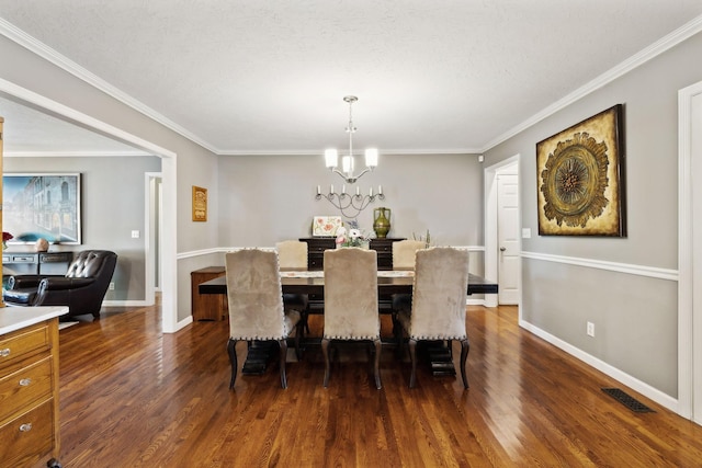 dining area featuring baseboards, a chandelier, and dark wood-style floors