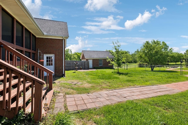 view of yard featuring a fenced backyard and stairway