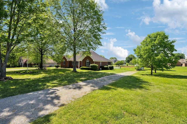 exterior space featuring a yard and driveway