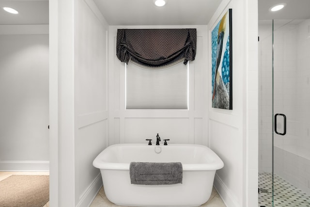 bathroom featuring recessed lighting, a freestanding tub, and a shower stall