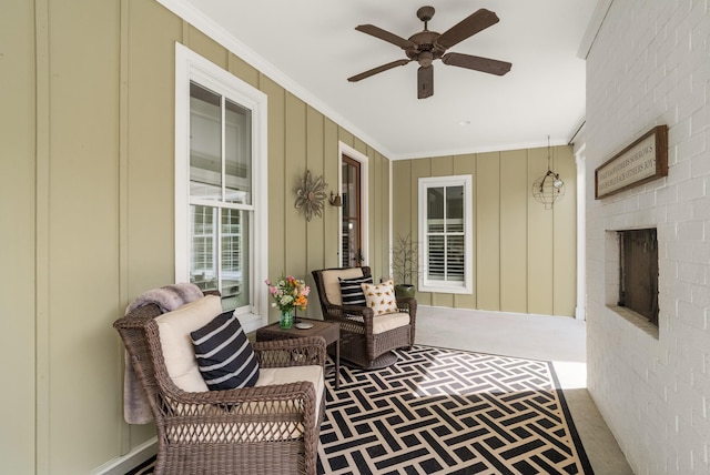 exterior space featuring ceiling fan and a fireplace