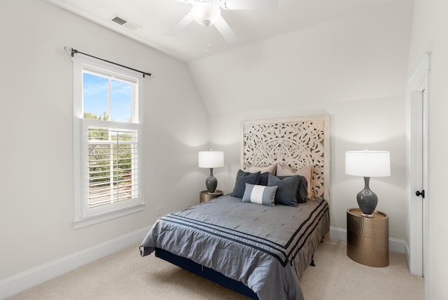 bedroom featuring carpet floors, baseboards, visible vents, and lofted ceiling