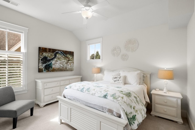 bedroom featuring visible vents, baseboards, vaulted ceiling, and light carpet