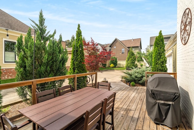 deck featuring area for grilling, a residential view, and outdoor dining area