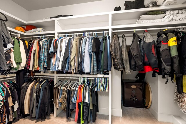 walk in closet with carpet floors