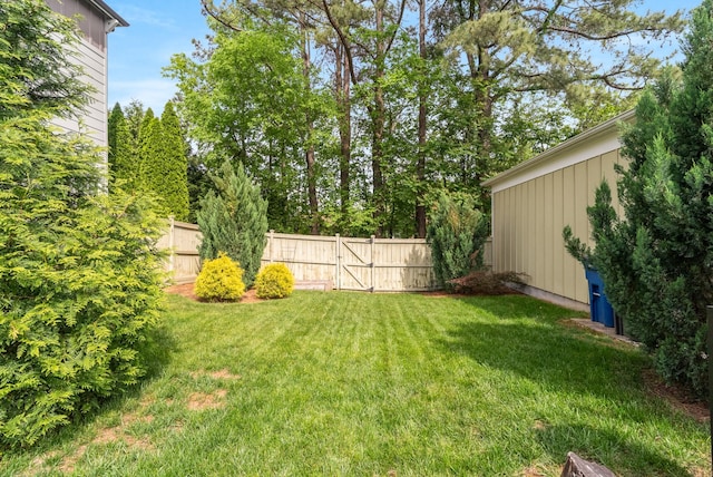 view of yard featuring fence and a gate