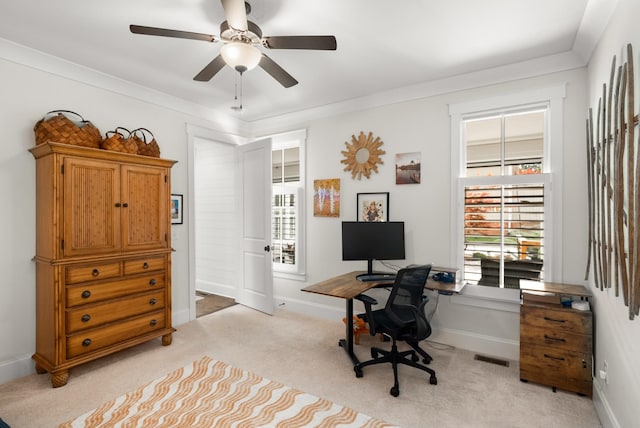 office space with ceiling fan, visible vents, light carpet, and a healthy amount of sunlight