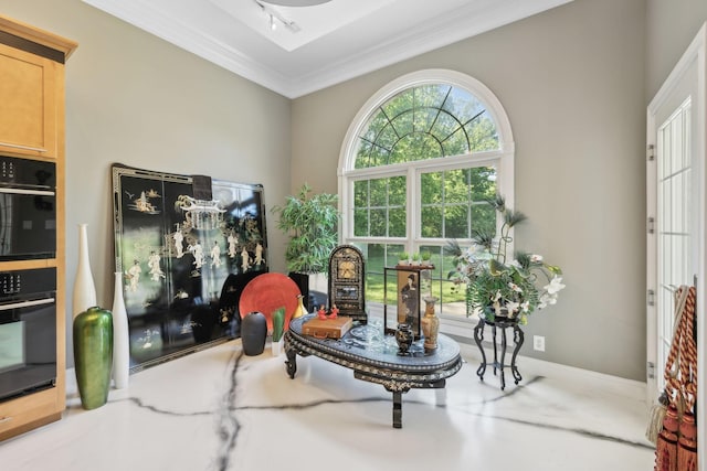 sitting room featuring baseboards and ornamental molding