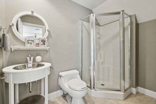 bathroom featuring toilet, a shower stall, and tile patterned flooring