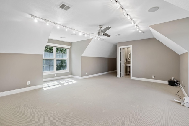 bonus room with baseboards, a ceiling fan, vaulted ceiling, and carpet flooring