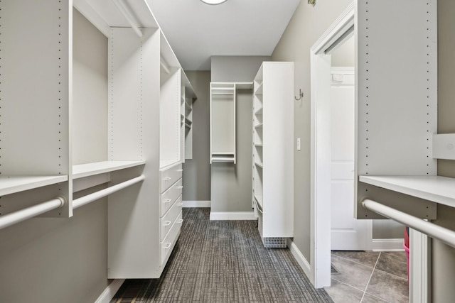 walk in closet with carpet