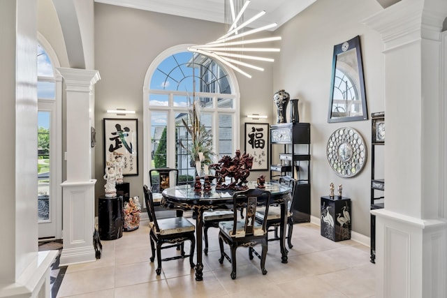 dining room featuring ornate columns, plenty of natural light, and light tile patterned floors