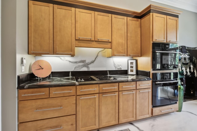 kitchen with dark stone counters and black appliances