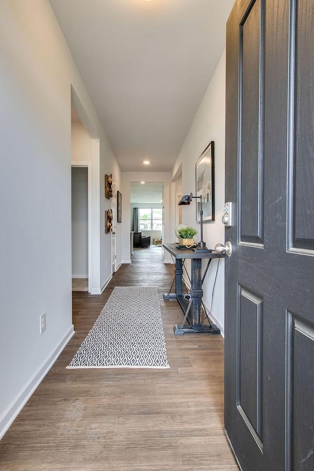 foyer with baseboards and wood finished floors