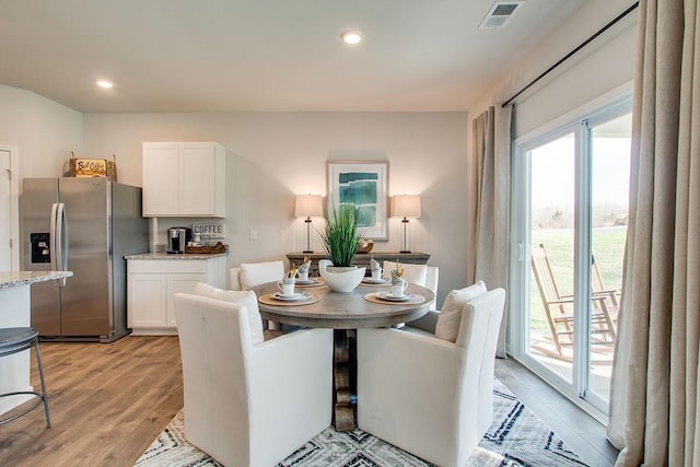 dining room featuring recessed lighting, visible vents, and light wood-type flooring